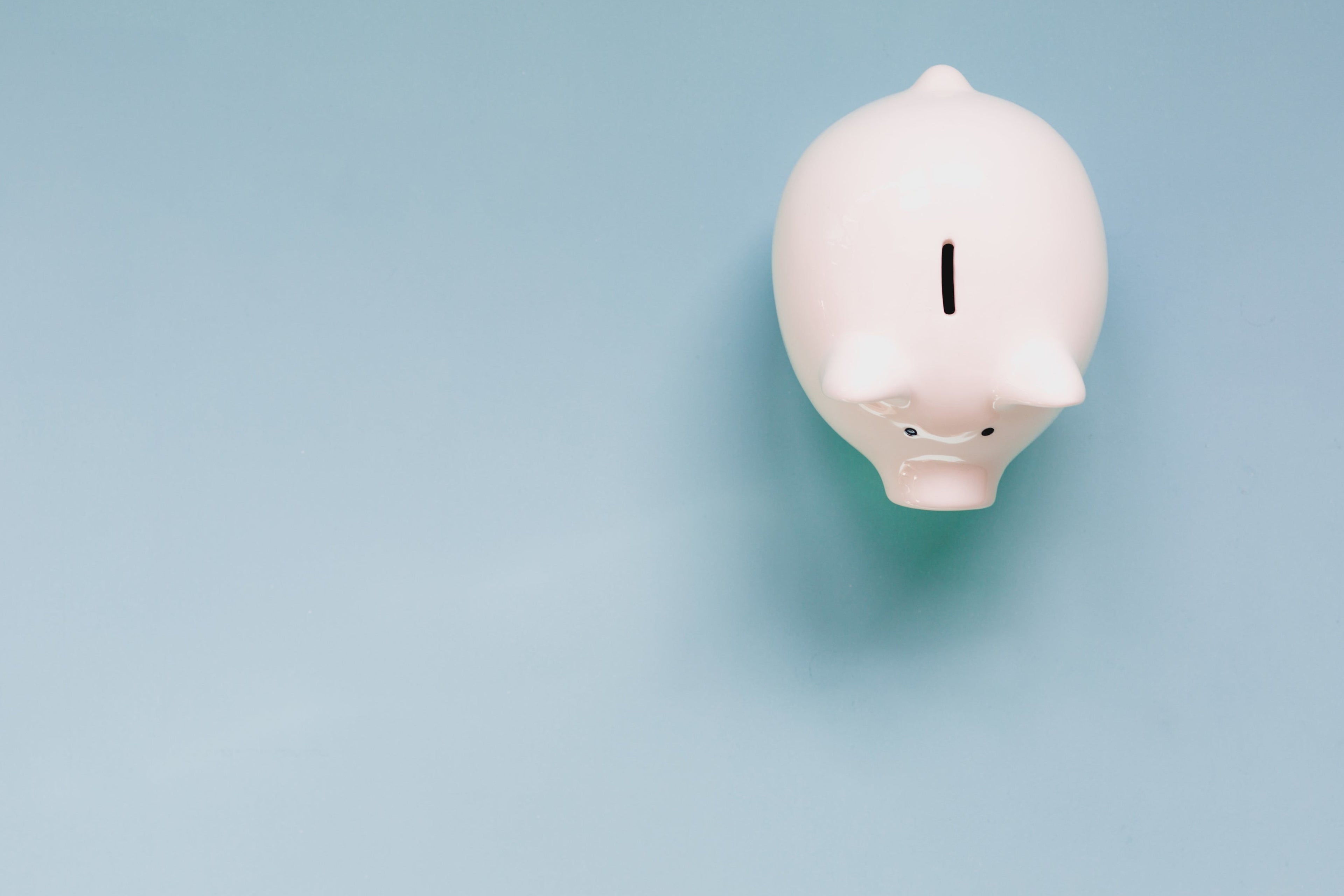 White piggy bank on a light blue background